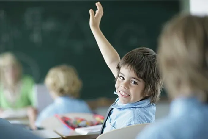 Framed Print : School boy raising hand in class Framed Print : School boy raising hand in class
