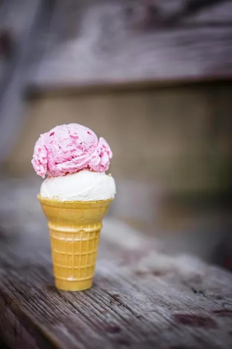 Framed Print : A scoop of coconut and a scoop of strawberry ice cream in an ice cream cone on a wooden table Framed Print : A scoop of coconut and a scoop of strawberry ice cream in an ice cream cone on a wooden table