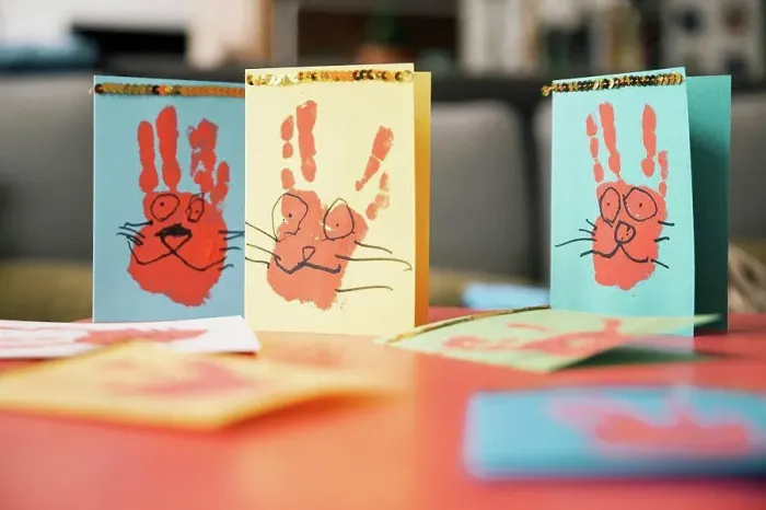 Framed Print : Self-made Easter bunny cards with handprints on a table