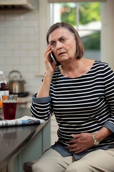 Framed Print : Senior Caucasian woman in her kitchen describing her abdominal pain to doctor on the phone Framed Print : Senior Caucasian woman in her kitchen describing her abdominal pain to doctor on the phone