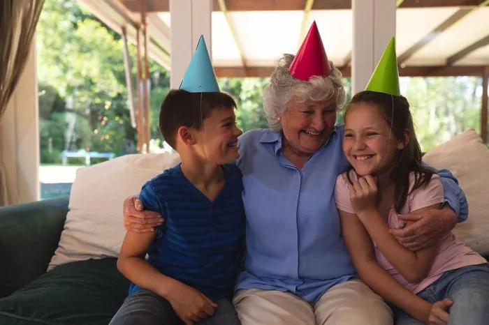 Framed Print : Senior caucasian woman spending time at home celebrating a birthday with her grandchildren