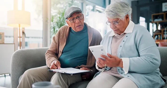 Framed Print : Senior couple, calculator and documents on couch with finance Framed Print : Senior couple, calculator and documents on couch with finance