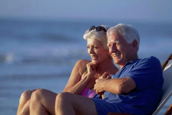 Framed Print : Senior couple sitting together in a chair and smiling Framed Print : Senior couple sitting together in a chair and smiling