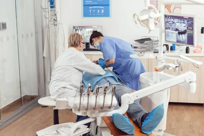 Framed Print : Senior dentist doctor and nurse preparing patient for removing crowns