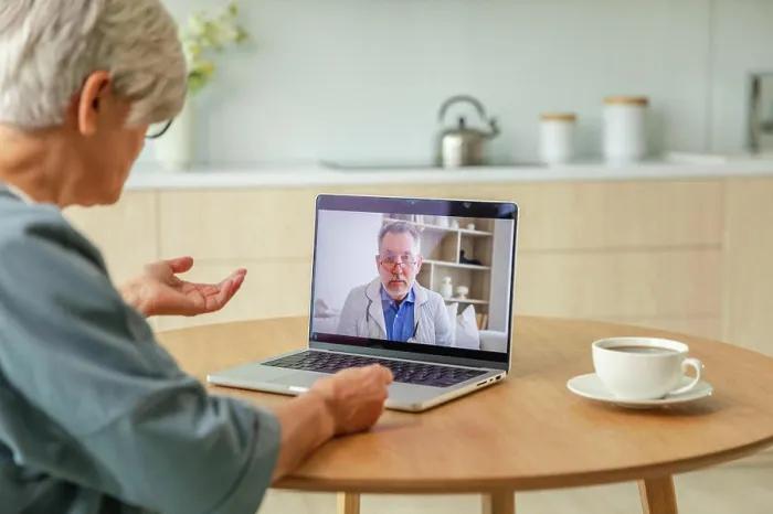 Framed Print : Senior doctor expert examine older seniors online Framed Print : Senior doctor expert examine older seniors online