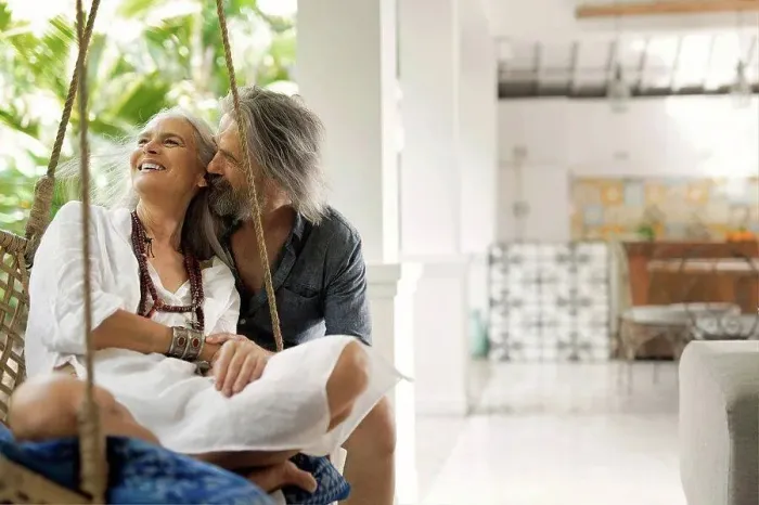 Framed Print : Senior man taking selfie at poolside while his wife is playing the guitar Framed Print : Senior man taking selfie at poolside while his wife is playing the guitar