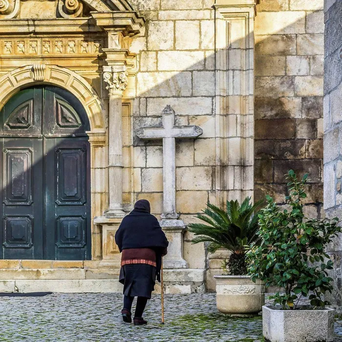 Framed Print : Senior woman approaching a church; Lamego Municipality, Viseu District, Portugal