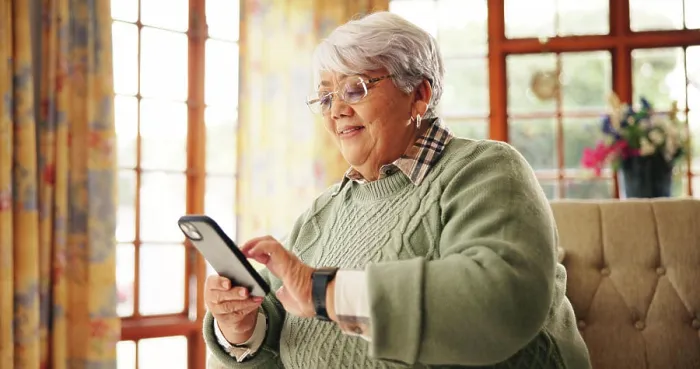 Framed Print : Senior woman, scroll or phone on sofa for online news Framed Print : Senior woman, scroll or phone on sofa for online news