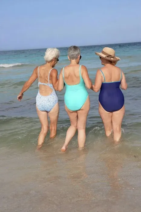 Framed Print : Senior women walking in waves on beach Framed Print : Senior women walking in waves on beach