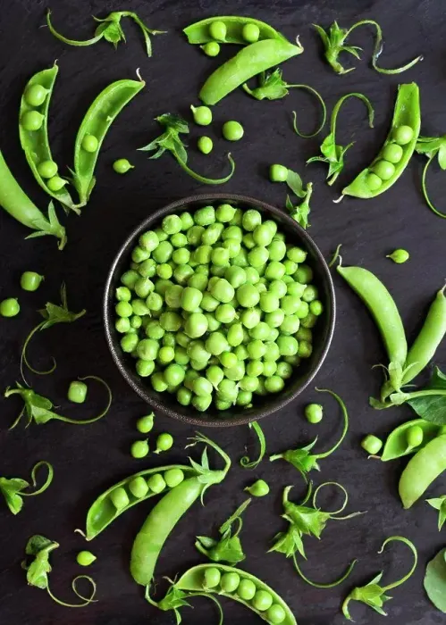 Framed Print : Shelled green peas and pea pods on a black background Framed Print : Shelled green peas and pea pods on a black background