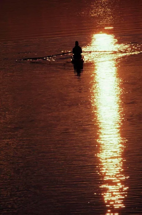 Framed Print : Silhouette of a man rowing a boat amidst the river Framed Print : Silhouette of a man rowing a boat amidst the river