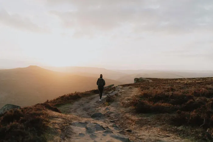 Framed Print : Silhouetted woman watching sunset from tranquil cliff, Bamford Edge, Derbyshire, England