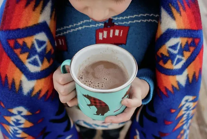 Framed Print : sky view of a boy wrapped in a blanket holding a hot chocolate outside Framed Print : sky view of a boy wrapped in a blanket holding a hot chocolate outside