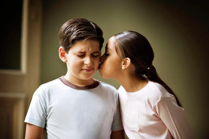 Framed Print : A small girl is kissing a small boy Framed Print : A small girl is kissing a small boy