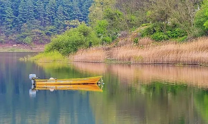 Framed Print : Small yellow metal fishing boat with small engine mount floating peacefully on a lake in South Korea Framed Print : Small yellow metal fishing boat with small engine mount floating peacefully on a lake in South Korea