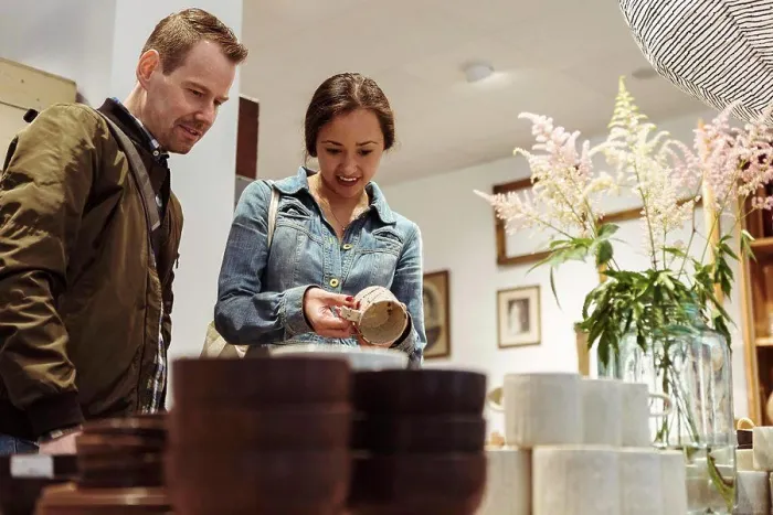Framed Print : Smiling couple choosing crockery at boutique Framed Print : Smiling couple choosing crockery at boutique