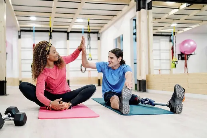 Framed Print : Smiling disabled athlete giving high-five to friend in gym