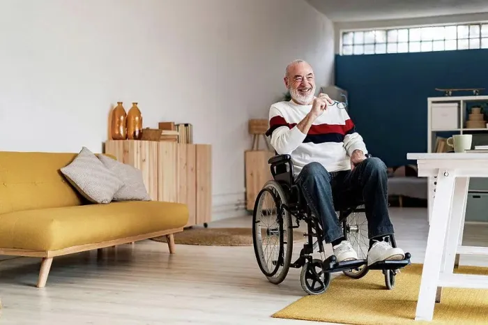 Framed Print : Smiling senior freelancer on wheelchair in living room Framed Print : Smiling senior freelancer on wheelchair in living room
