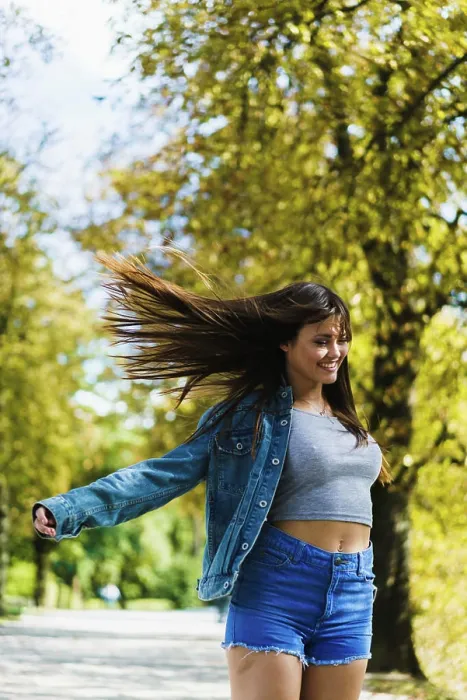 Framed Print : Smiling woman with flying hair walking in sunny autumn park
