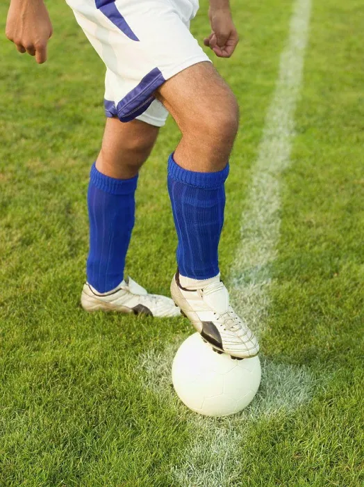 Framed Print : A soccer player with his foot on a soccer ball Framed Print : A soccer player with his foot on a soccer ball