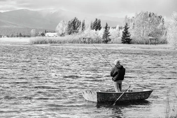 Framed Print : Solo fisherman standing in small boat on Frenchtown Lake, Montana Framed Print : Solo fisherman standing in small boat on Frenchtown Lake, Montana