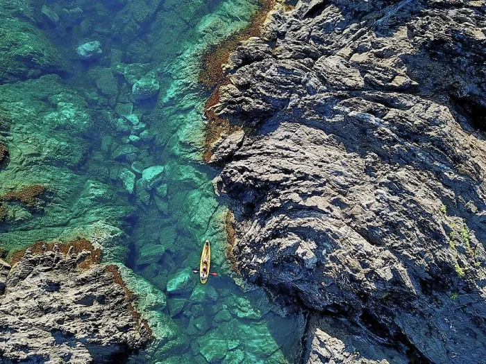 Framed Print : Spain, Catalonia, Costa Brava, Aerial view of man in kayak near rocky coast Framed Print : Spain, Catalonia, Costa Brava, Aerial view of man in kayak near rocky coast