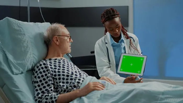 Framed Print : Specialist woman showing green screen on tablet to patient Framed Print : Specialist woman showing green screen on tablet to patient