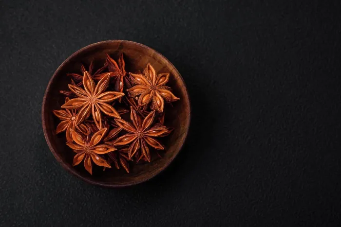 Framed Print : Star shaped spice star anise in a wooden round bowl Star shaped spice star anise in a wooden round bowl on a dark