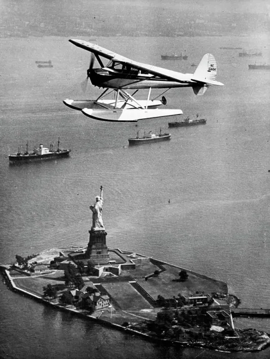 Framed Print : Statue Of Liberty In New York Harbour -- Aerial view shows seaplane flying overhead Framed Print : Statue Of Liberty In New York Harbour -- Aerial view shows seaplane flying overhead