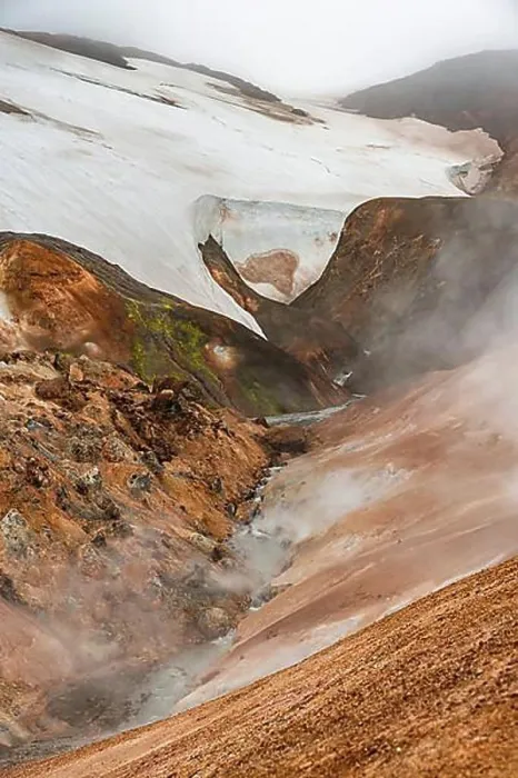 Framed Print : Steaming stream between colourful rhyolite mountains and snowfields