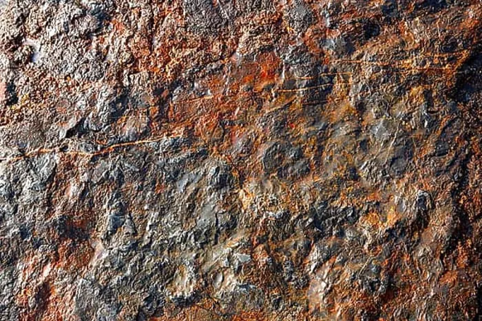 Framed Print : Stone texture in the beach shore with red oxide