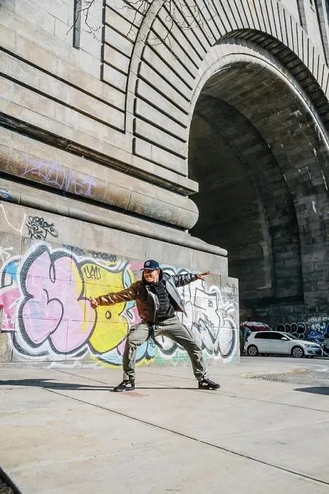 Framed Print : Street dancer poses wide near colorful graffiti and stone arch Framed Print : Street dancer poses wide near colorful graffiti and stone arch