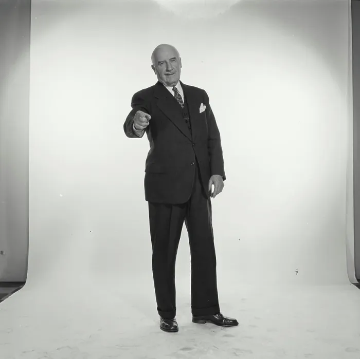 Framed Print : Studio portrait of senior businessman pointing forward
