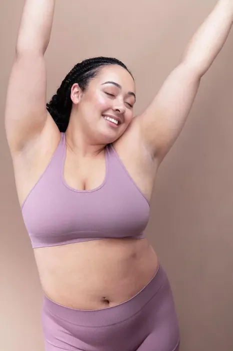 Framed Print : Studio shot of smiling woman in underwear with eyes closed and arms raised Framed Print : Studio shot of smiling woman in underwear with eyes closed and arms raised