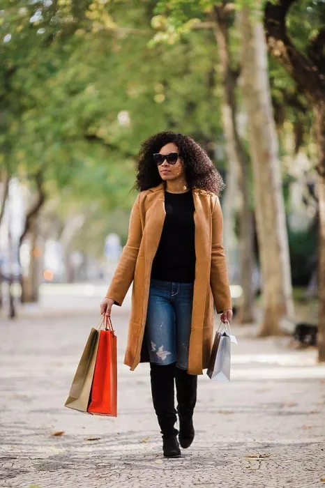 Framed Print : Stylish young woman walking with shopping bags on sidewalk Framed Print : Stylish young woman walking with shopping bags on sidewalk