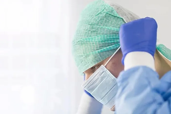 Framed Print : Surgeon doctor in sterile gloves preparing for operation in hospital. He is wearing surgical cap and blue gown Framed Print : Surgeon doctor in sterile gloves preparing for operation in hospital. He is wearing surgical cap and blue gown