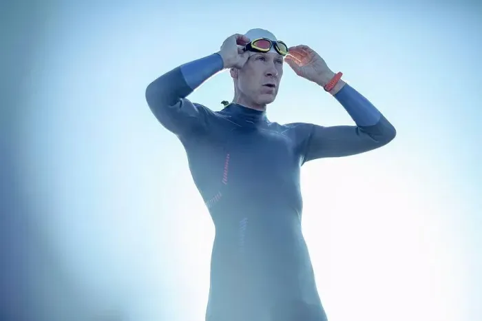Framed Print : A swimmer in a wetsuit and swimming hat, adjusting his swimming goggles Framed Print : A swimmer in a wetsuit and swimming hat, adjusting his swimming goggles