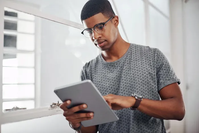 Framed Print : Tablet, business and black man research online for information or networking in startup office Framed Print : Tablet, business and black man research online for information or networking in startup office