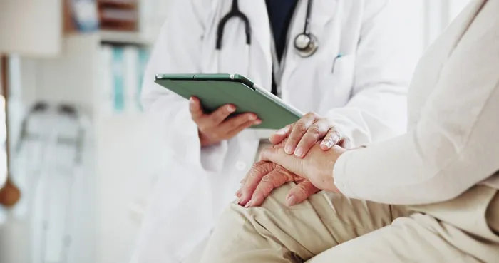 Framed Print : Tablet, doctor and holding hands of old woman in office for consulting Framed Print : Tablet, doctor and holding hands of old woman in office for consulting