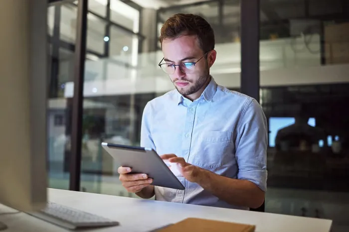 Framed Print : Tablet planning, night research and businessman working on the internet in a dark office at work
