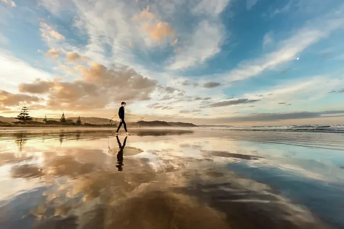 Framed Print : Teen with surfboard on a beach in New Zealand at sunset Framed Print : Teen with surfboard on a beach in New Zealand at sunset