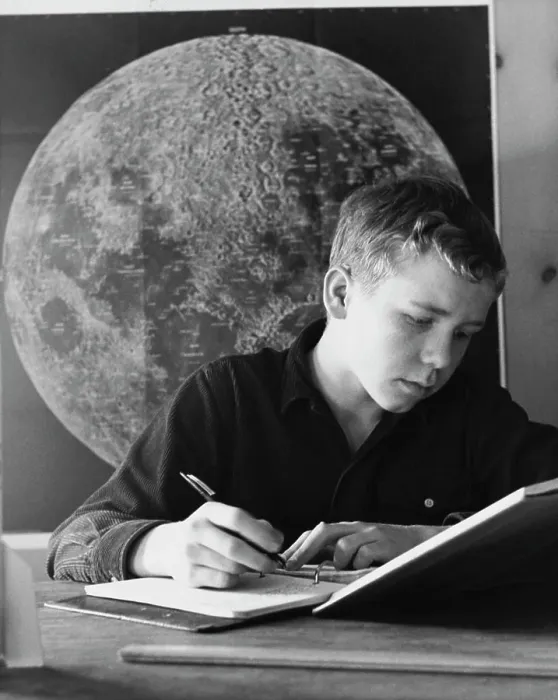 Framed Print : Teenage boy writing in a spiral notebook Framed Print : Teenage boy writing in a spiral notebook