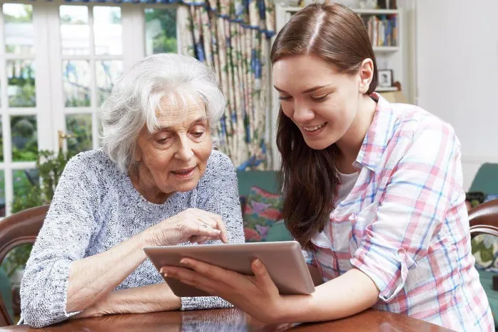 Framed Print : Teenage Granddaughter Showing Grandmother How To Use Digital Tablet Framed Print : Teenage Granddaughter Showing Grandmother How To Use Digital Tablet