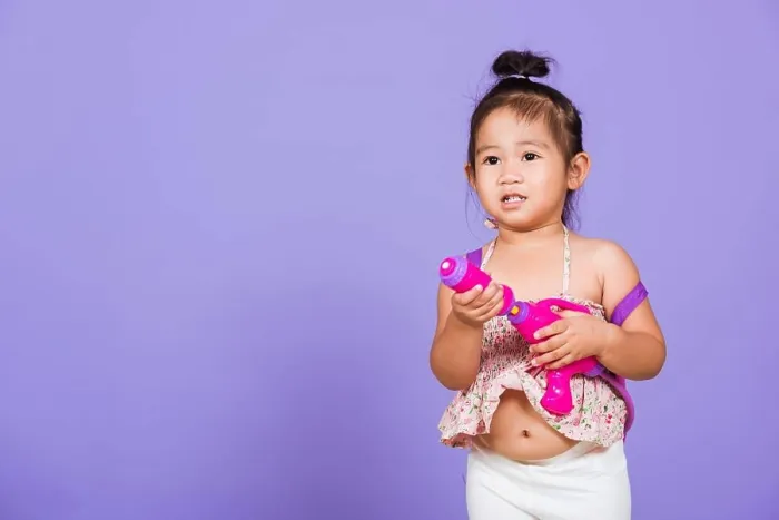 Framed Print : Thai child funny hold toy water pistol and smile Framed Print : Thai child funny hold toy water pistol and smile