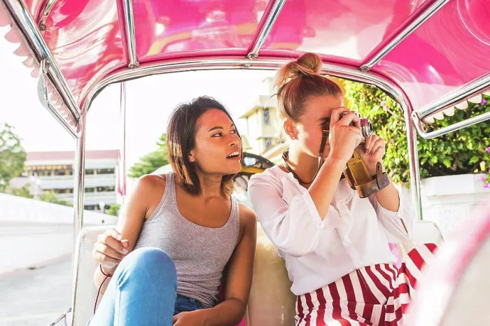 Framed Print : Thailand, Bangkok, two friends riding tuk tuk taking pictures with an old camera Framed Print : Thailand, Bangkok, two friends riding tuk tuk taking pictures with an old camera