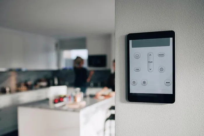 Framed Print : Thermostat app on digital tablet mounted over white wall at home
