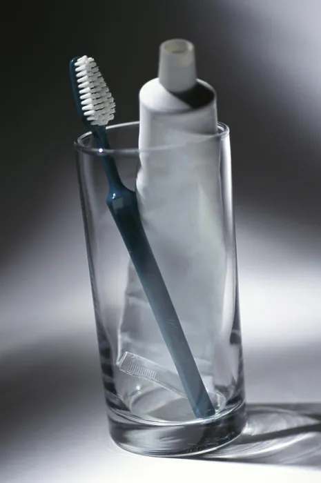 Framed Print : Toothbrush and a tube of toothpaste in a glass Framed Print : Toothbrush and a tube of toothpaste in a glass