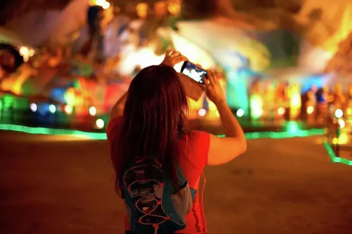 Framed Print : Tourist taking photograph of light decorations, Batu Caves, Kuala Lumpur, Malaysia