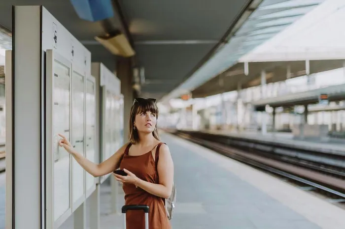 Framed Print : Tourist woman walking inside the train station in Antwerp