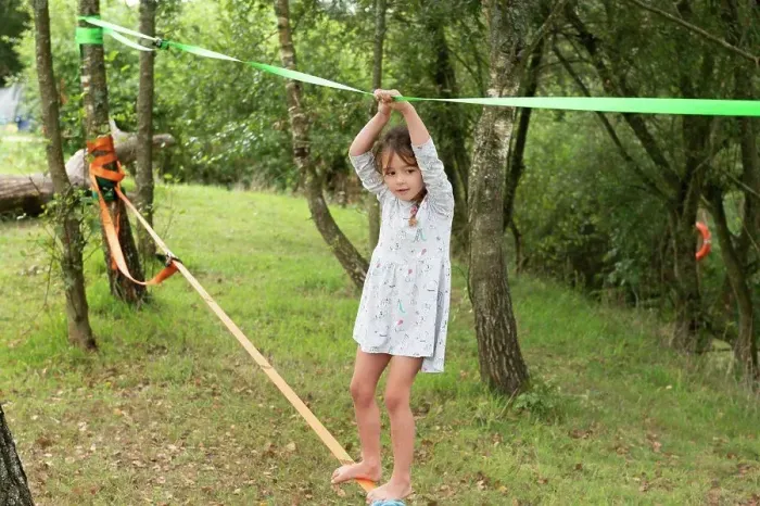 Framed Print : UK, Girl on slackline in park Framed Print : UK, Girl on slackline in park